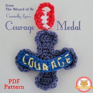 May include: Crocheted medal with a blue and yellow "COURAGE" banner, a red heart-shaped top, and the text "from The Wizard of Oz Cowardly Lion's Courage Medal".