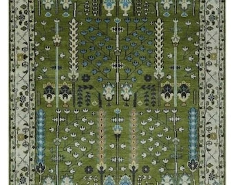 May include: A green rug with a traditional Persian design featuring intricate floral patterns and a border with a repeating motif.