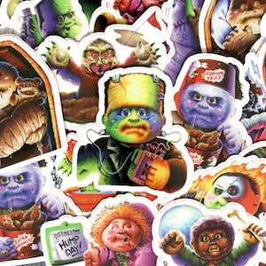 May include: A collection of colorful stickers featuring various monster characters. The stickers are round, oval, and rectangular in shape and feature a variety of expressions. Some of the characters include a monster with a bandage on its head, a monster with a green face, and a monster with a red face. The stickers are perfect for adding a touch of fun and whimsy to any project.