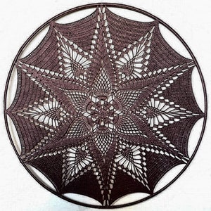 May include: A handcrafted, dark brown crochet dream catcher with a detailed starburst design. The intricate openwork pattern is set within a circular frame, creating a decorative wall hanging. The design features a central floral motif and radiating points.