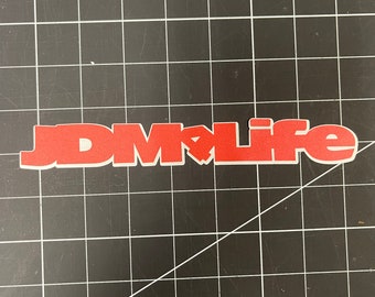 May include: Red vinyl sticker with the text "JDM LIFE" in bold white letters.