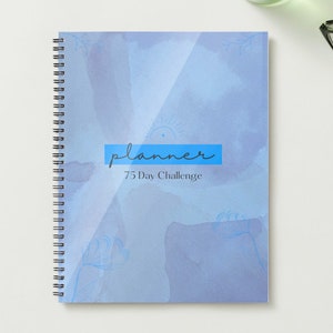 May include: A blue and white planner with a watercolor background and the text "planner 75 Day Challenge".