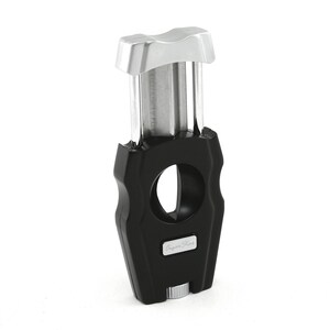 May include: A black and silver cigar cutter with a guillotine blade and a "Cigar Star" logo.