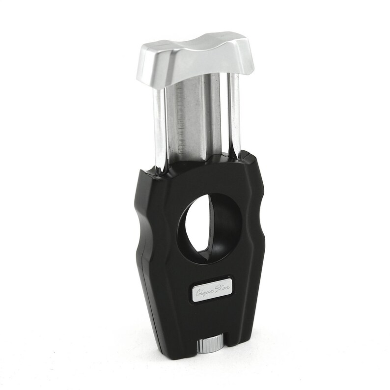 May include: A black and silver cigar cutter with a guillotine blade and a "Cigar Star" logo.