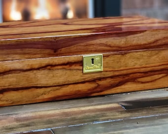 Large humidor will store up to 110 cigars. Made from exotic Padouk wood finished with 15 coats of lacquer. 4 cedar dividers.