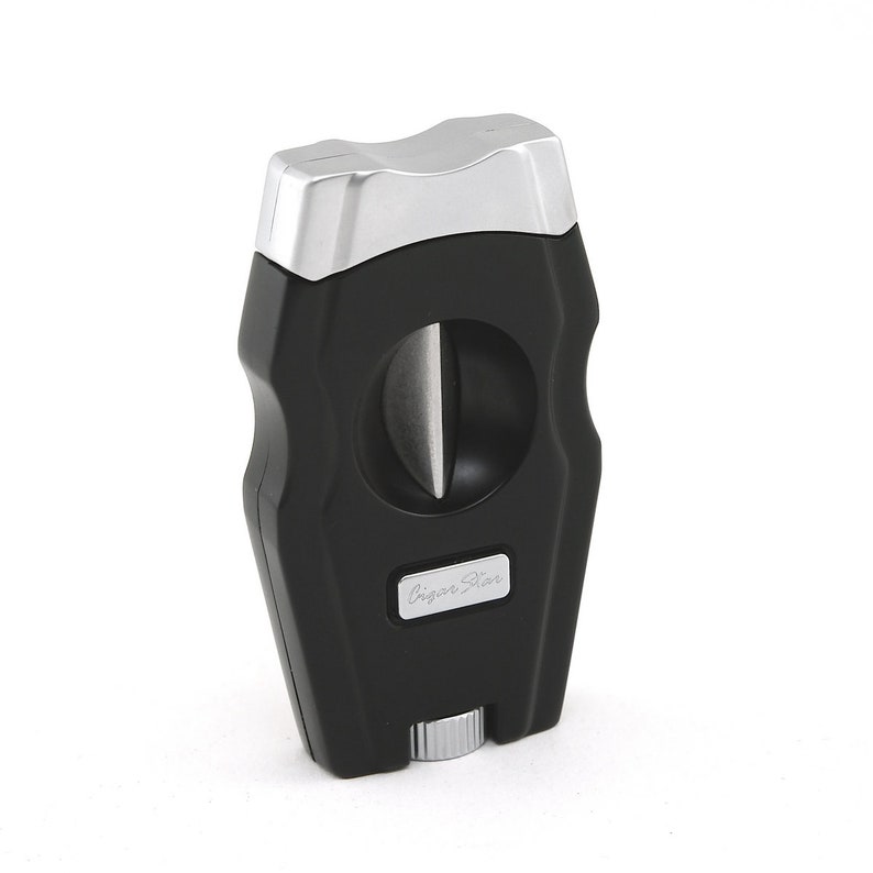 May include: Black cigar cutter with a silver top and a silver "Cigar Star" logo.