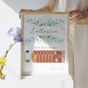 May include: A framed print with a watercolor floral design and gold glitter. The print says "Katharina" and "Deine erste Million!" with a 100,000 Euro bill image. The print is signed "Laura und Jan."