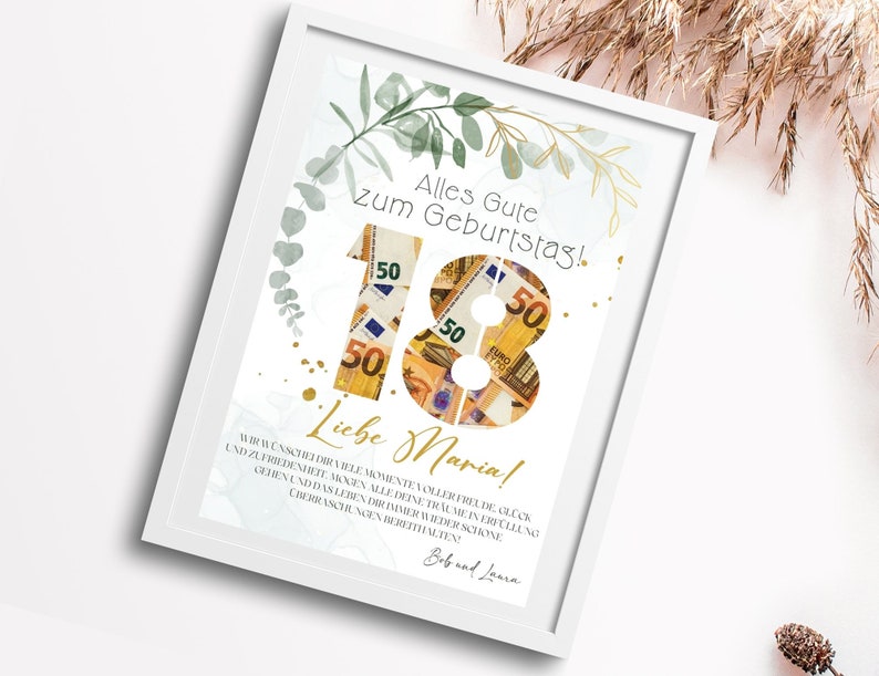 May include: A white framed print with a gold and green floral design. The number 18 is made of euro bills. The text "Alles Gute zum Geburtstag!" and "Liebe Maria!" is printed on the print.