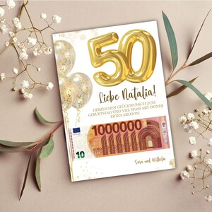 K&ouml;nnte beinhalten: Eine wei&szlig;e Karte mit goldenem Konfetti und einem goldenen Ballon in Form der Zahl 50. Die Karte tr&auml;gt den Text "Liebe Natalia!" und "HERZLICHEN GL&Uuml;CKWUNSCH ZUM GEBURTSTAG UND VIEL SPASS MIT DEINER ERTEN MILLION!"  Die Karte zeigt au&szlig;erdem ein Bild eines 10-Euro-Scheins mit der Nummer 1000000 darauf. Die Karte ist signiert mit "Sara und Wilhelm."