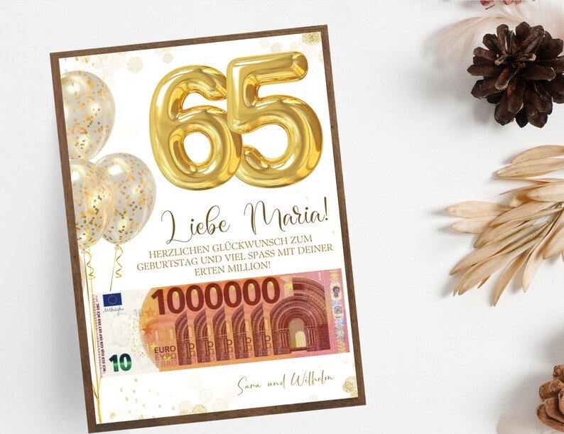Op de afbeelding: Een ingelijste verjaardagskaart met een gouden "65" ballonontwerp. De kaart bevat Duitse tekst, gouden confetti ballonnen en een afbeelding van een miljoen euro biljet. Het is een verjaardagscadeau.