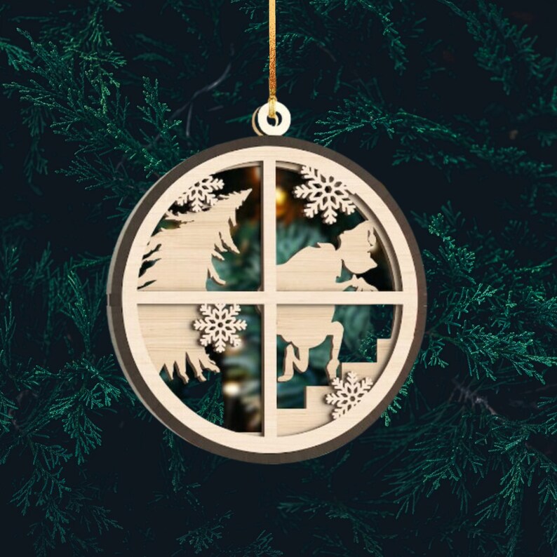 May include: A wooden Christmas ornament with a circular design. The ornament features a silhouette of a person climbing a staircase, a Christmas tree, and snowflakes. The ornament is painted in shades of brown.
