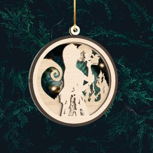 May include: A wooden Christmas ornament featuring a silhouette of Jack Skellington from The Nightmare Before Christmas. The ornament is round and has a brown border. The silhouette of Jack Skellington is holding a pumpkin and standing in front of a silhouette of his house.