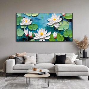 May include: A painting of white water lilies with yellow centers, surrounded by green lily pads and blue water. The painting is done in a textured style, giving the flowers and leaves a 3D effect.
