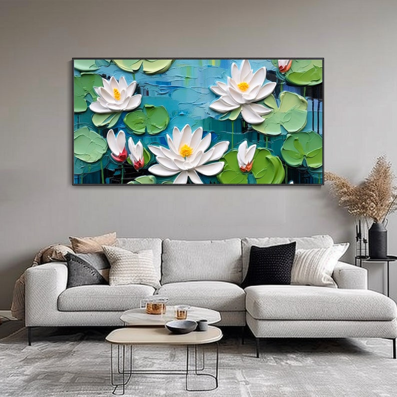 May include: A painting of white water lilies with yellow centers, surrounded by green lily pads and blue water. The painting is done in a textured style, giving the flowers and leaves a 3D effect.