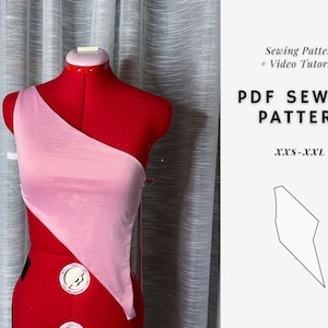 May include: A pink and red fabric top on a dress form. The top is a one-shoulder style with a diagonal cut. The text on the right side of the image reads "Sewing Pattern + Video Tutorial PDF Sewing Pattern XXS-XXL".