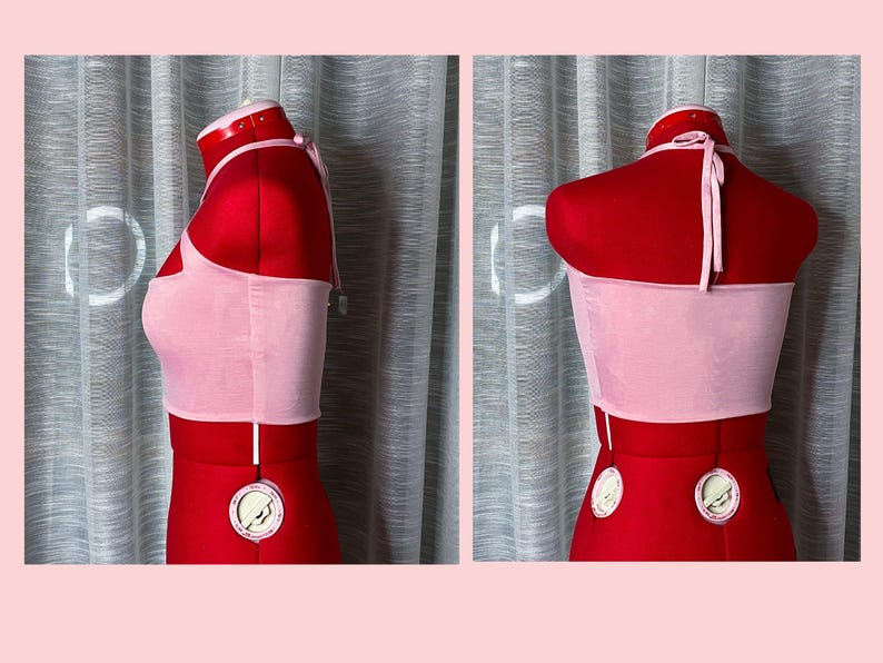 May include: A pink halter top with a thin strap. The top is made of a soft, stretchy fabric and has a cropped fit.