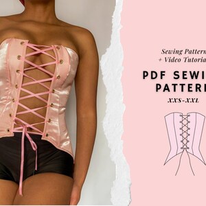May include: A light pink corset with a lace-up front and gold-colored eyelets. The corset is paired with black shorts. Text on the right side reads "PDF SEWING PATTERN" and "XXS-XXL".