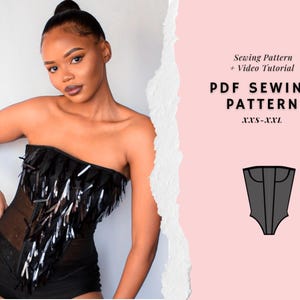 May include: A black strapless top with fringe and a PDF sewing pattern. The top features a sheer mesh panel and is adorned with black fringe and silver sequins. The pattern includes a video tutorial and is available in sizes XXS-XXL.