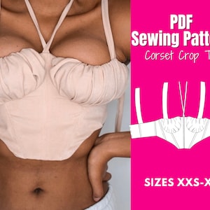May include: A light peach-colored corset crop top with a halter neck and tie straps. The top features a gathered bust and a structured bodice. The image includes the text "PDF Sewing Pattern Corset Crop Top" and "SIZES XXS-XXL" on a pink background.