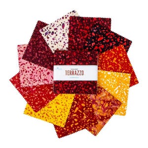 May include: A collection of colorful fabric squares arranged in a circular pattern. The squares feature a speckled design in shades of red, yellow, and white. A central bundle of fabric is labeled "Volcanic Terrazzo Elementals."