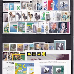 May include: A collection of postage stamps with diverse designs, including portraits, landscapes, and historical figures. The stamps are arranged in rows and columns, displaying various designs and denominations. Some stamps have text, including "DEUTSCHLAND" and "FILM".