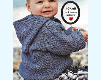 May include: A blue knitted hooded sweater with a textured stitch pattern. The image includes a black oval graphic with the text 40% off on 2 or more patterns and a red heart icon. The sweater is worn over pants with a blue, white, and black stripe.