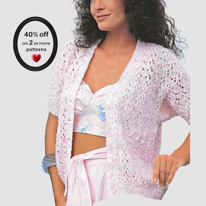 May include: A short-sleeved, open-front cardigan featuring a delicate, lacy knit pattern in a variegated blend of white and soft pink yarn. A circular black graphic in the upper left corner displays the text 40% off on 2 or more patterns.
