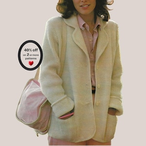 May include: A cream-coloured, long-sleeved, ribbed knit cardigan with a collared neckline and two front pockets, worn over a light pink button-down shirt. A black circular graphic with the text 40% off on 2 or more patterns and a red heart icon.
