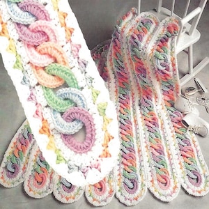 May include: Two crocheted scarves with a chain link pattern. The scarves have a white base with pastel chain links in pink, blue, green, and orange. The edges are scalloped and trimmed with matching colours.