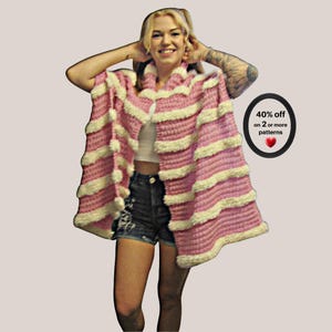 May include: A pink and white striped crochet poncho featuring a textured, fuzzy yarn finish. To the right, a black oval badge displays the text: 40% off on 2 or more patterns, accompanied by a small red heart icon.