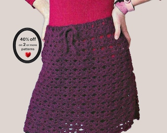 May include: A dark purple crochet skirt featuring an openwork pattern and a drawstring waist. The skirt is worn over a red long-sleeved top. A black circular graphic on the left displays the text 40% off on 2 or more patterns.