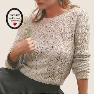 May include: A long-sleeved beige sweater featuring an intricate, repeating leaf-like knit pattern with a round neckline and ribbed cuffs. The garment is paired with a black skirt. A circular graphic in the corner displays the text 40% off on 2 or more patterns.