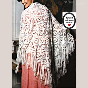 May include: A white crochet shawl featuring a repeating circular floral motif pattern and long fringe trim along the bottom edge. The text on the image reads PDF Pattern and 40% off on 2 or more patterns with a red heart icon.