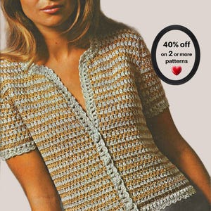 May include: A short-sleeved crochet cardigan featuring alternating horizontal stripes of metallic gold and silver yarn. The garment has a V-neckline and a textured stitch pattern throughout. A black circular badge displays the text 40% off on 2 or more patterns with a red heart icon.