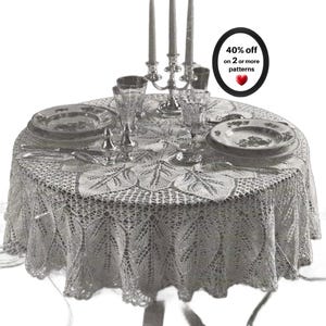 May include: A round white lace tablecloth featuring a detailed leaf pattern. The table is set with two plates, two crystal glasses, a silver candelabra with three candles, and silverware. A black circular graphic displays 40% off on 2 or more patterns.