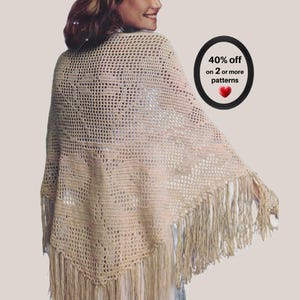 Può includere: Uno scialle all'uncinetto color beige con un motivo a griglia traforato e lunghe frange lungo i bordi inferiori. Un grafico ovale nero nell'angolo in alto a destra contiene il testo 40% off on 2 or more patterns con un piccolo cuore rosso.