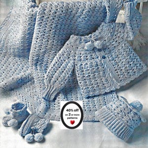 May include: A light blue crochet baby set featuring a long-sleeve cardigan with pom-poms, a matching hat with a pom-pom, and booties with pom-poms, alongside a textured blanket. A central label displays the text 40% off on 2 or more patterns.