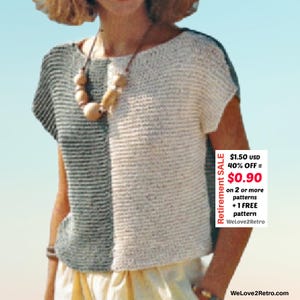 May include: A short-sleeved, two-toned top with a split design. One side is a striped gray, and the other is a solid cream color. The top is paired with a wooden bead necklace. The image includes text that says "Retirement SALE".