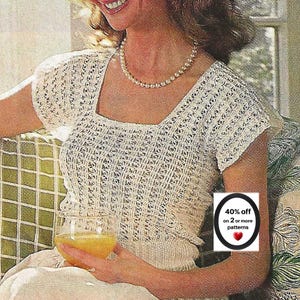 May include: A short-sleeved, cream-colored knit top with a square neckline and a vertical openwork pattern. The garment is worn with a beaded necklace. A circular graphic overlay displays the text 40% off on 2 or more patterns with a red heart icon.