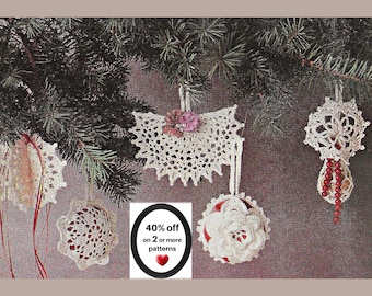May include: Four crocheted ornaments hanging from pine branches. The ornaments feature intricate white lace patterns, some with red accents, beads, or fabric flowers. A central graphic displays the text 40% off on 2 or more patterns.
