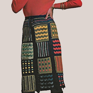 May include: A midi-length skirt featuring a black base with a patchwork design of various crocheted squares. The squares display diverse textures and patterns in colors including mustard yellow, forest green, bright red, and navy blue.