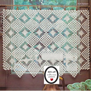 May include: A rectangular off-white crochet curtain featuring a repeating diamond and floral motif pattern. The piece is suspended from a metal rod with clips. A small white sign in the foreground displays the text 40% off on 2 or more patterns.