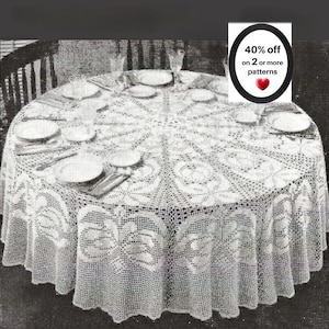 May include: A round white crocheted tablecloth with a detailed floral pattern draped over a circular table set with plates and silverware. A black oval graphic in the corner displays the text 40% off on 2 or more patterns with a red heart icon.