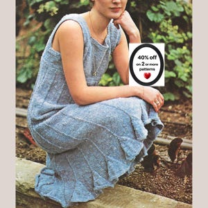 May include: A sleeveless, light blue knit dress with a textured, speckled appearance and vertical ribbed panels. The hem features a flared, ruffled design. A white rectangular graphic overlay displays the text 40% off on 2 or more patterns.