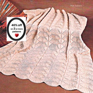May include: A light beige knitted blanket featuring a repeating fan-like lace pattern with a scalloped edge. The image includes text that reads PDF Pattern and 40% off on 2 or more patterns with a red heart icon on a white background.