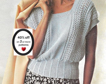 May include: A light blue knit top with a square neckline, short sleeves, and a ribbed hem. The garment features intricate cable and lace stitch patterns. A black oval graphic displays the text 40% off on 2 or more patterns with a red heart icon.