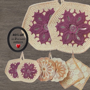 May include: A collection of crocheted textile items including two large hexagonal pieces with purple floral motifs on cream backgrounds, two smaller hexagonal purple floral pieces, two circular orange floral pieces, and two square cream pieces.