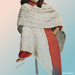 May include: A cream-colored, crocheted shawl with a scalloped edge. The shawl features an open, lacy design and is draped over a red garment. The overall aesthetic is vintage and handmade.