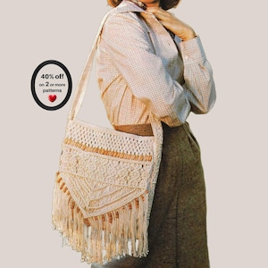May include: A cream-colored macrame shoulder bag featuring intricate knotted patterns, wooden bead accents, and long fringe detailing at the bottom. A black oval graphic with white text reads: 40% off on 2 or more patterns with a red heart icon.