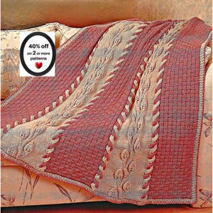 May include: A knitted blanket featuring alternating vertical panels of deep red and beige yarn. The design includes textured cable knit patterns, intricate leaf motifs, and a basketweave stitch. A circular graphic displays the text 40% off on 2 or more patterns.